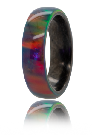 Ring featuring a multi-colored opal exterior and a forged carbon fiber interior. 