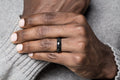 One carbon fiber radius ring with glossy finish displayed on a hand.