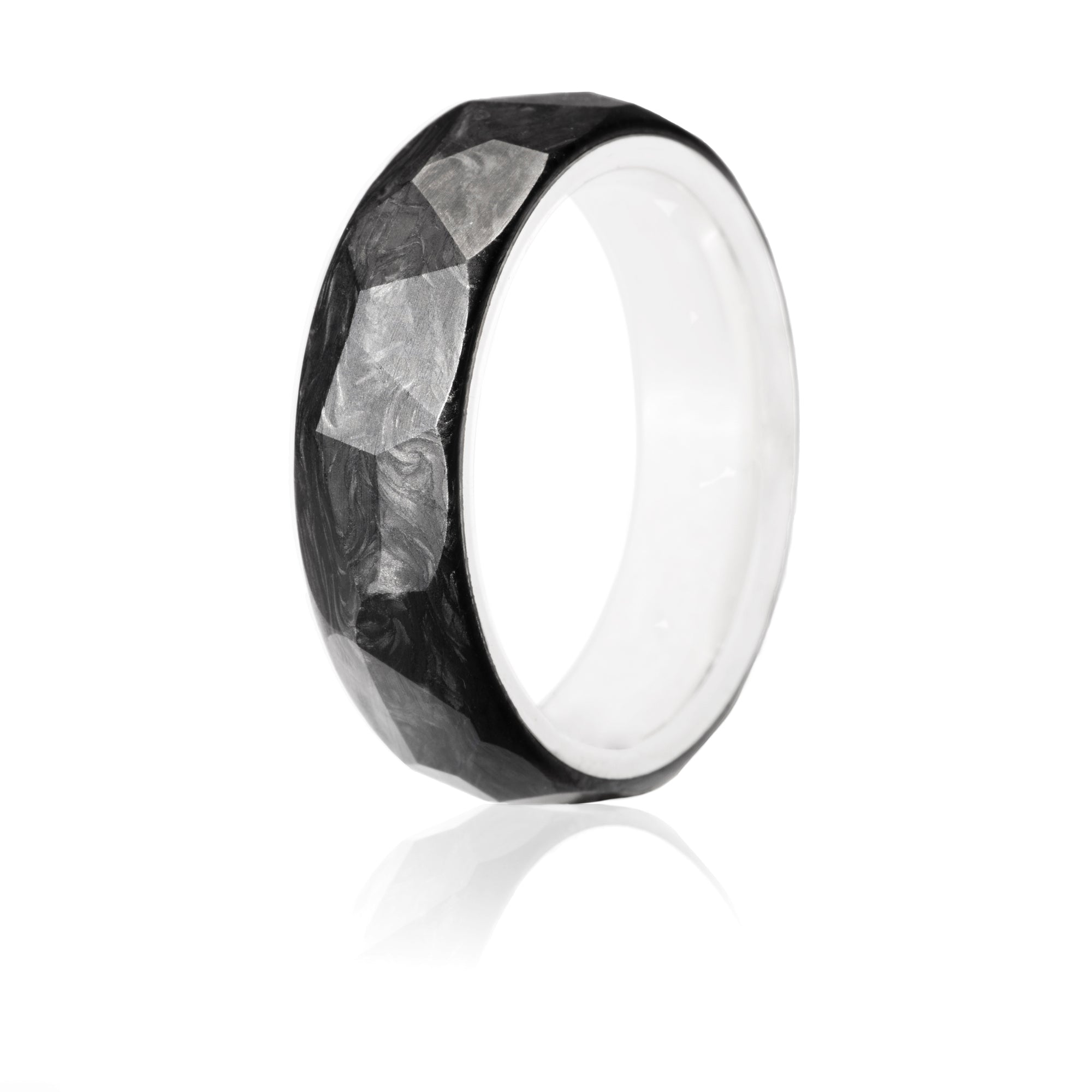 Forged carbon ring with faceted exterior and silver interior. 