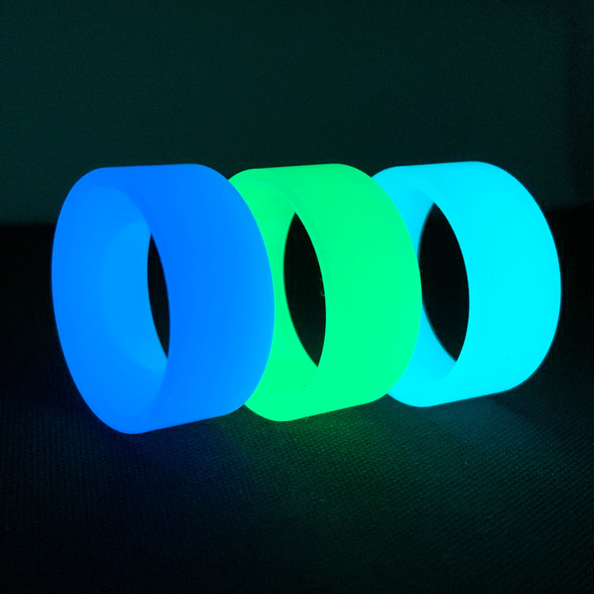 Turquoise, Green, and Blue Glow Rings made entirely from proprietary glow polymer.