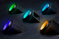Five carbon fiber radius rings with green, purple, blue, turquoise, and orange glow interiors. 