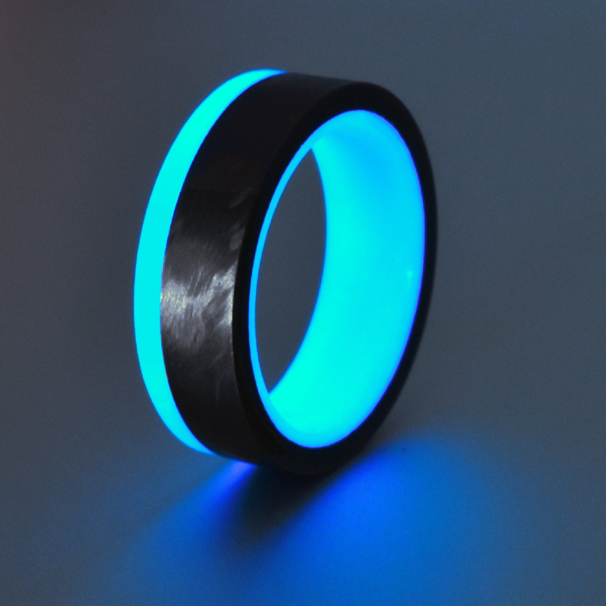 Turquoise Glow Ring with Filament Wound Carbon Fiber exterior and glow rim.