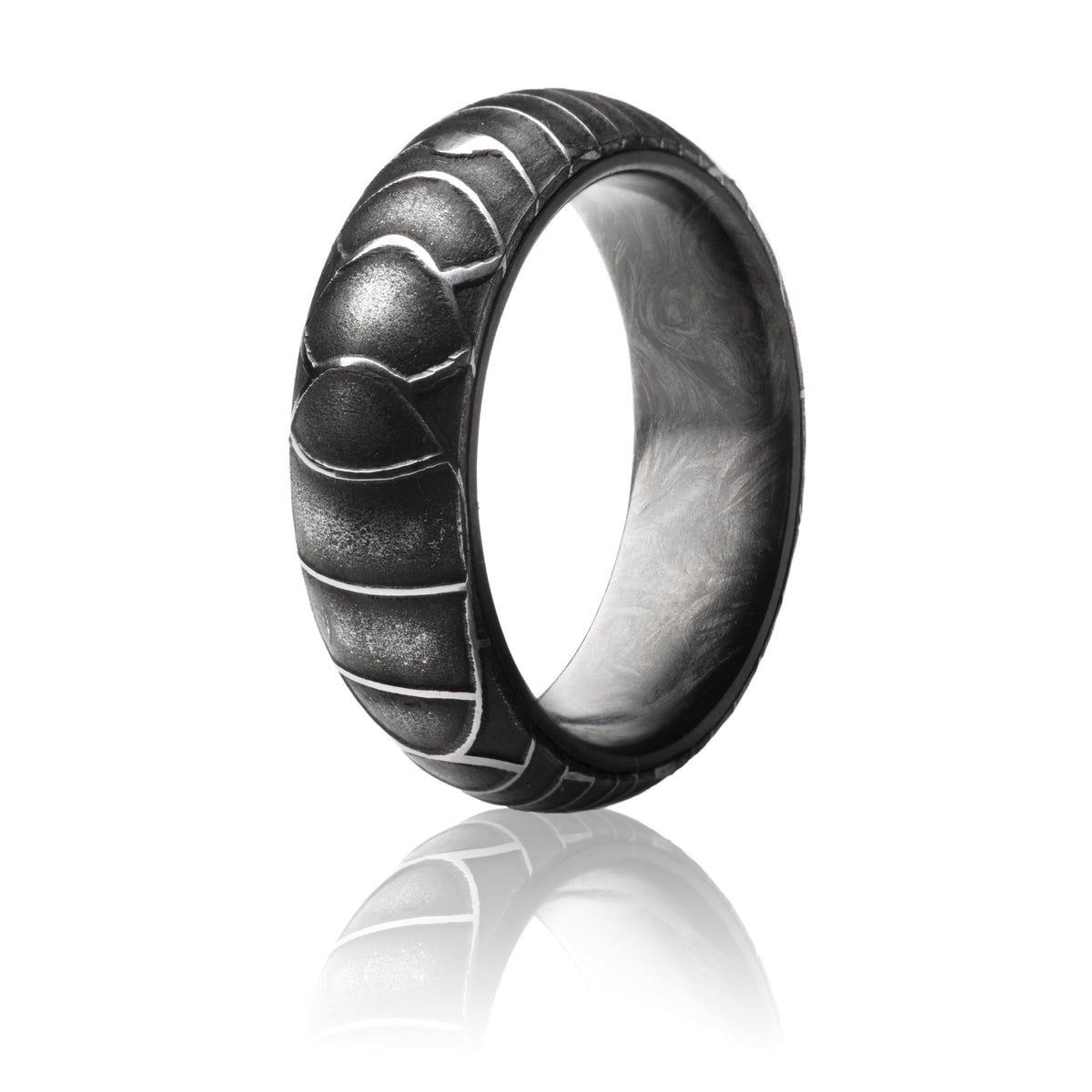 Damascus Steel Ring with exterior overlapping oval pattern and forged carbon fiber interior. 