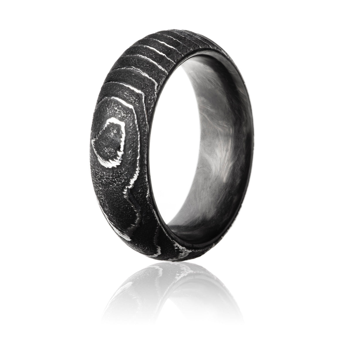 Damascus Steel ring with exterior scaly textured pattern and forged carbon fiber interior.