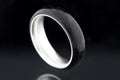 Carbon fiber radius ring with glossy finish and silver interior.