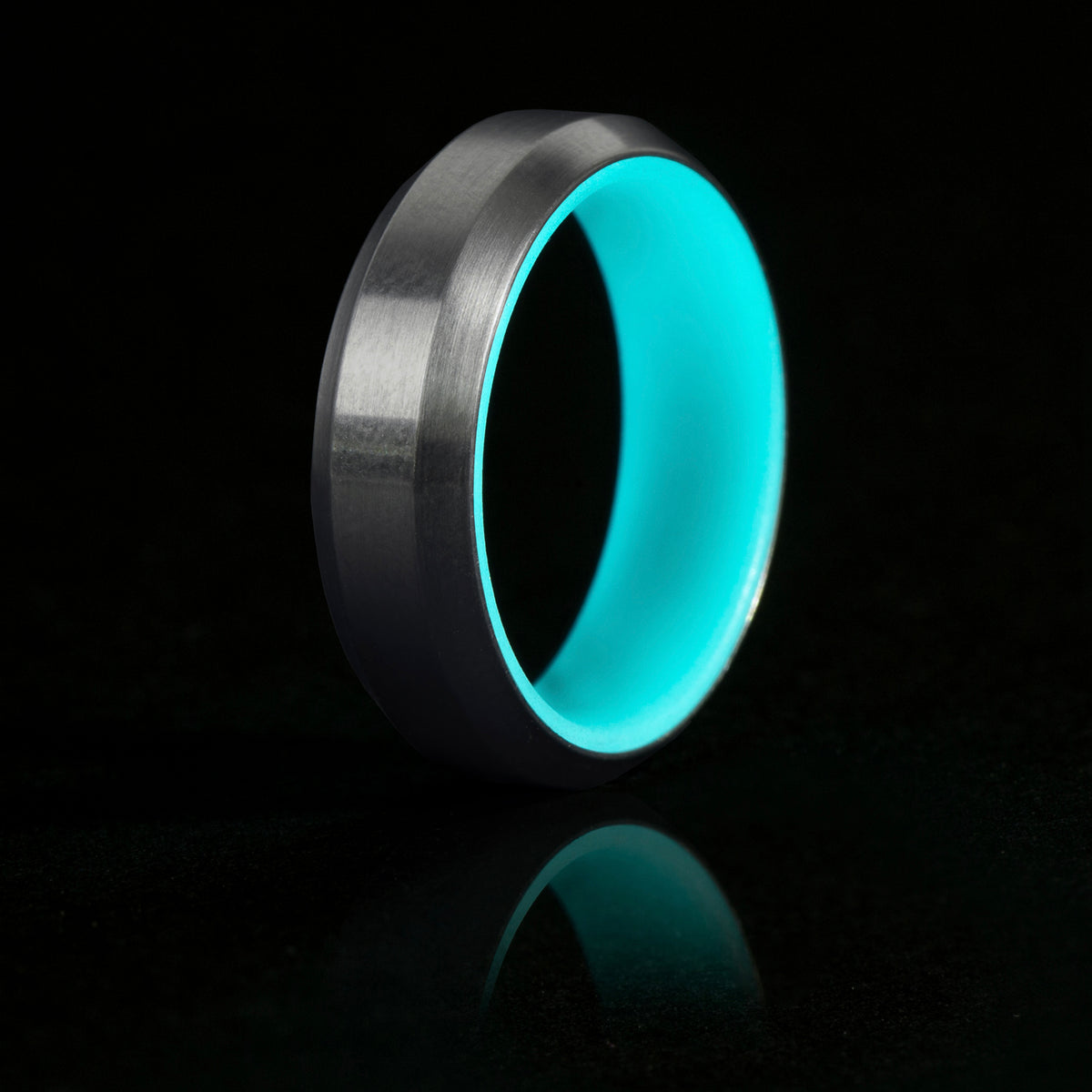 Turquoise glow ring with titanium exterior and beveled edges. 