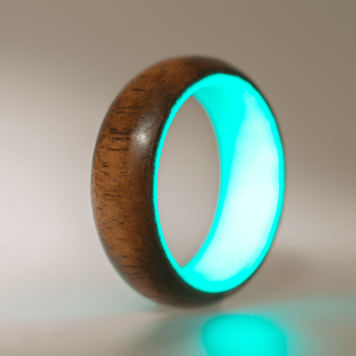 Turquoise glow ring with walnut wood exterior. 