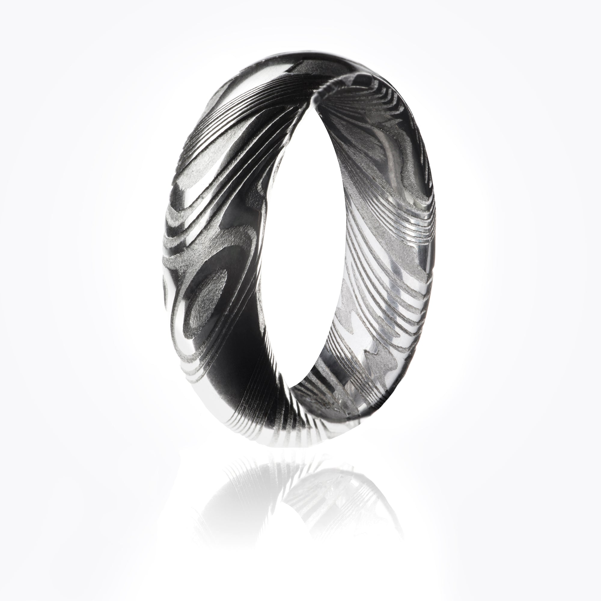 Damascus Steel radius ring with textured woodgrain pattern throughout interior and exterior. 