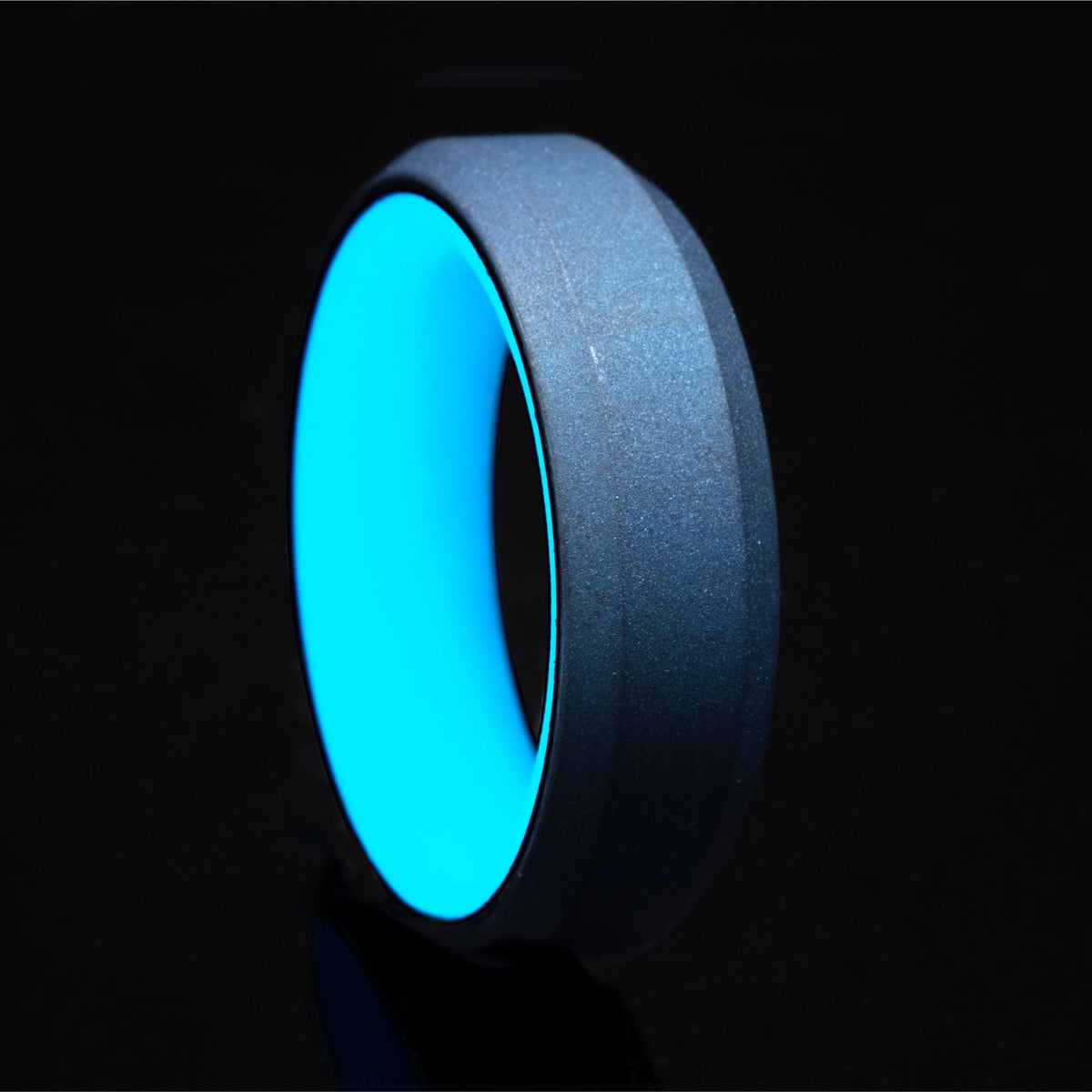 Turquoise glow ring with turquoise anodized titanium exterior and beveled edges.